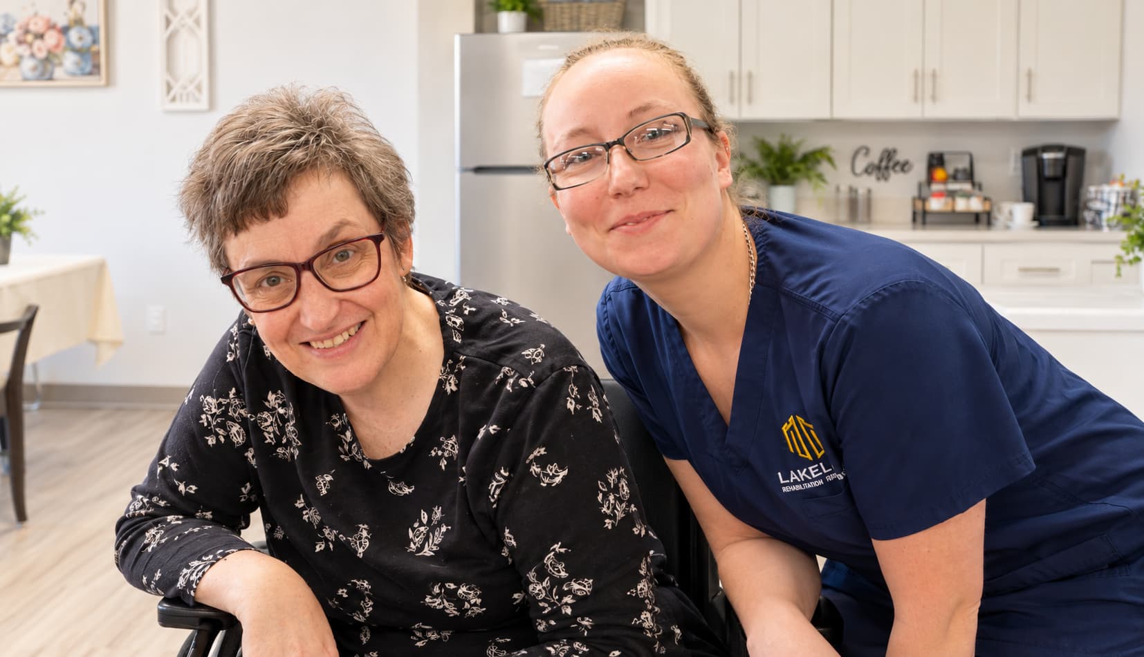 A Lakeland resident and caregiver smiling together